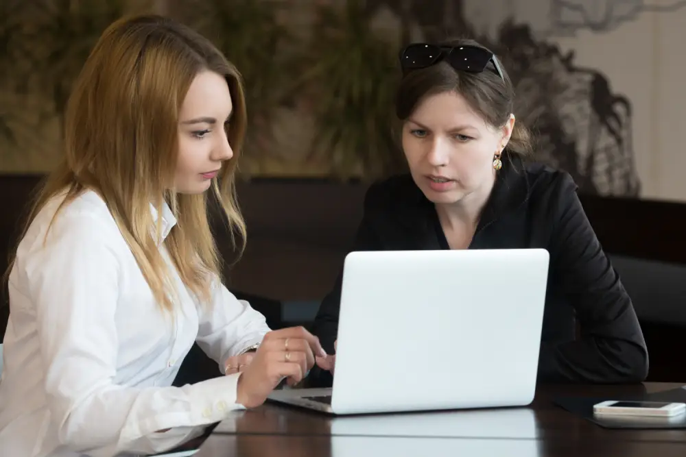 Amazon account management team working together on a client account at a laptop